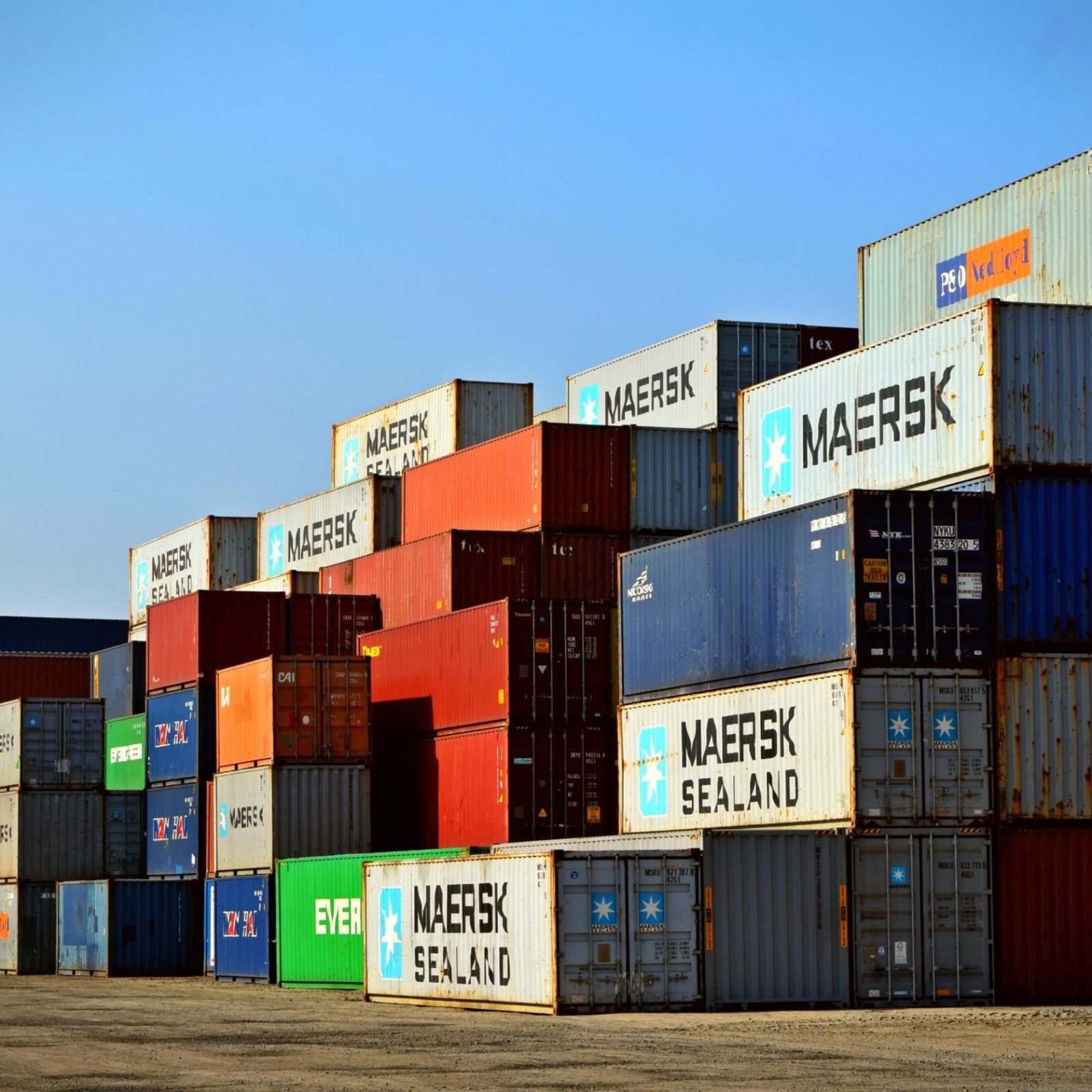 pexels-photo-906494-906494 Colorful stacked shipping containers at a port exemplify global logistics.